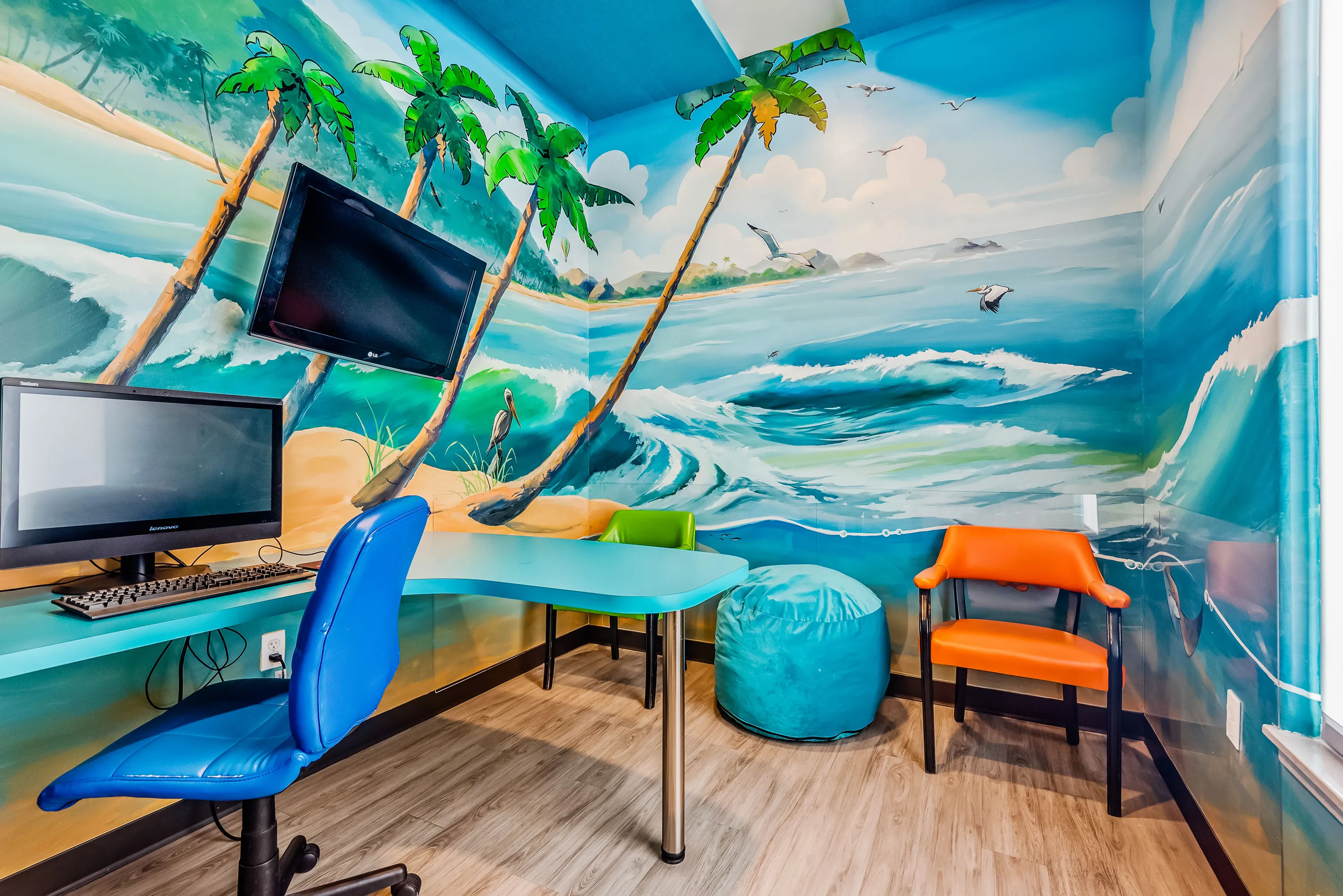 A private treatment room with a tropical beach mural at Super Smiles