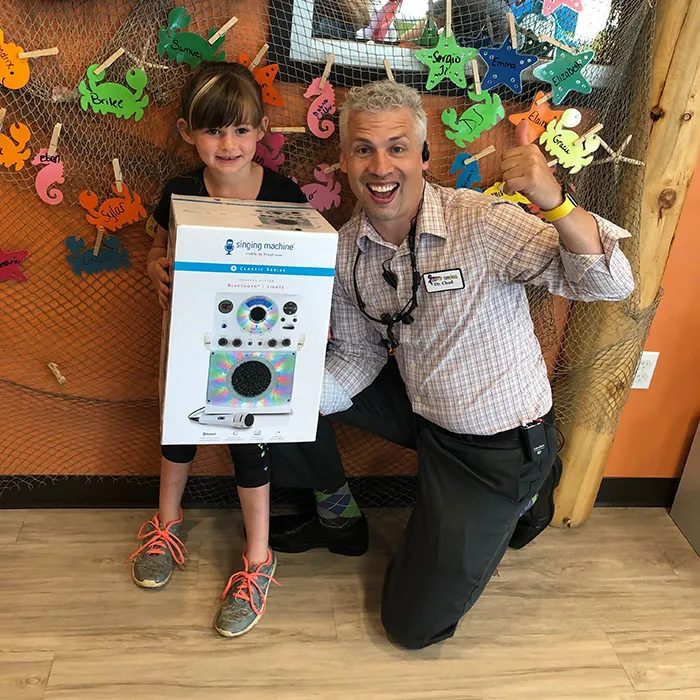 Dr. Jensen with a young Cavity Free Club winner at Super Smiles