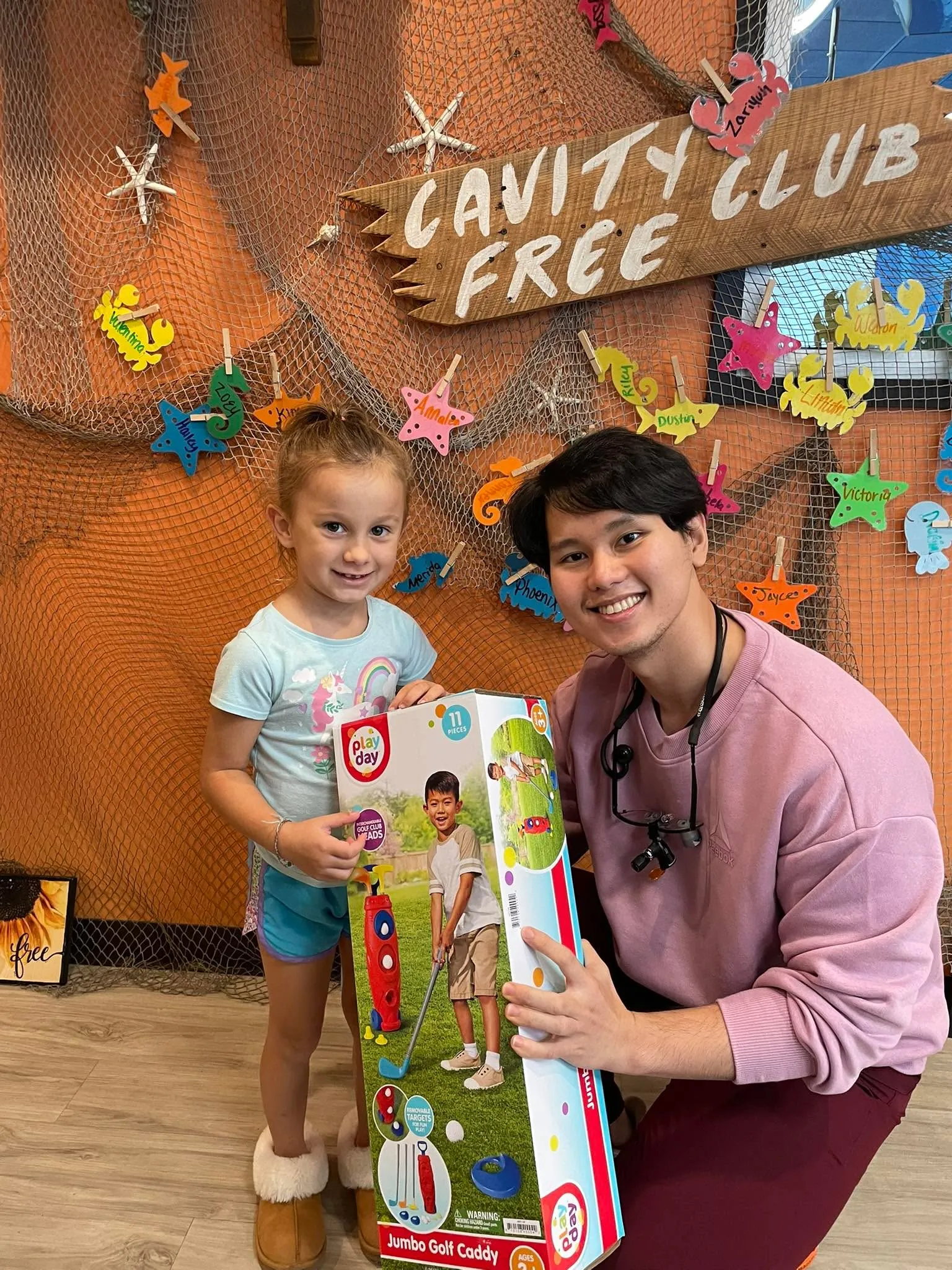 A small Cavity Free Club winner with a team member at Super Smiles
